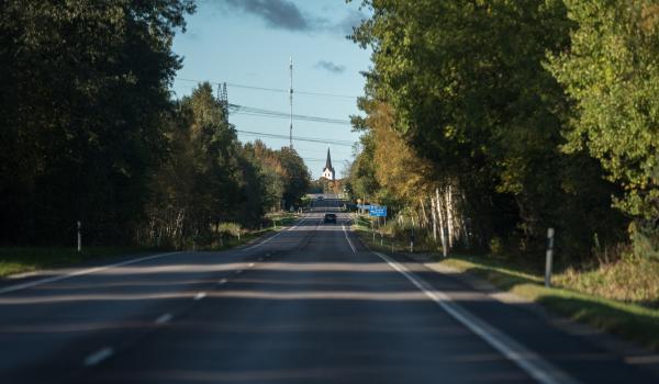Road with a church spire in distance 