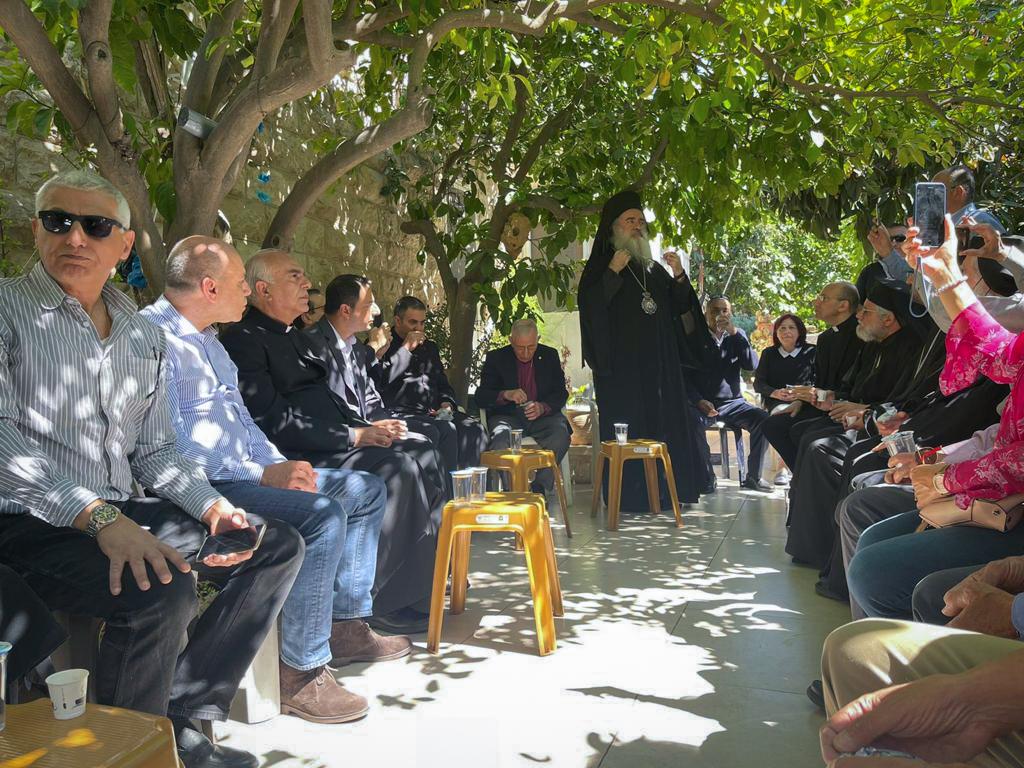 Christian delegation sits in a circle while visiting the neighbourhood of Sheikh Jarrah