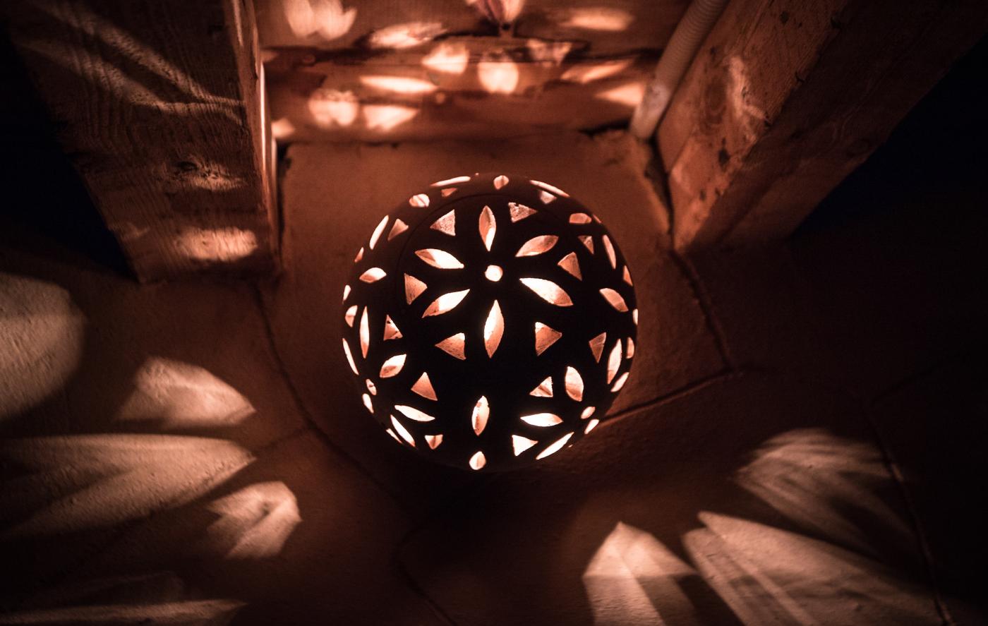 Candles in a globe-shaped urn burn at night outside a chapel in Egypt. 