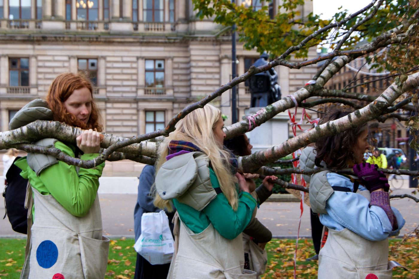 A group of young women carrying a dead tree during the Fridays for Future march for COP26, in Glasgow, UK, 5 November 2021.