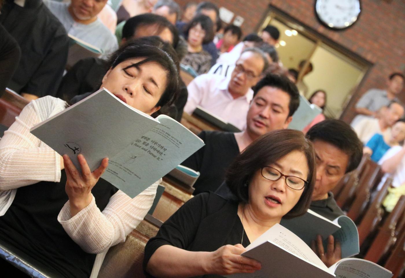 Congregation singing and praying in the church