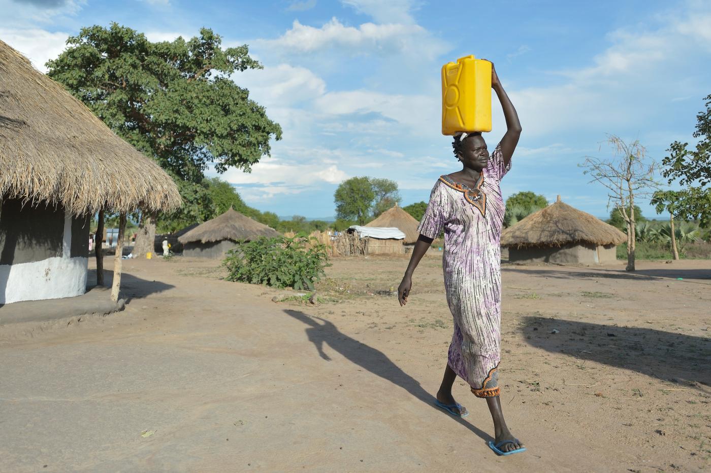 woman carries water Uganda