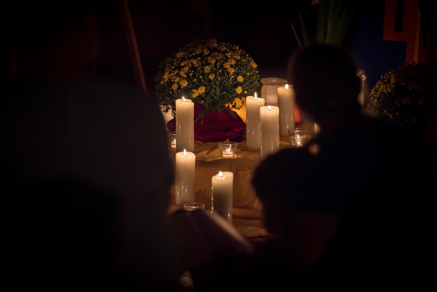 a collection of candles placed by the altar