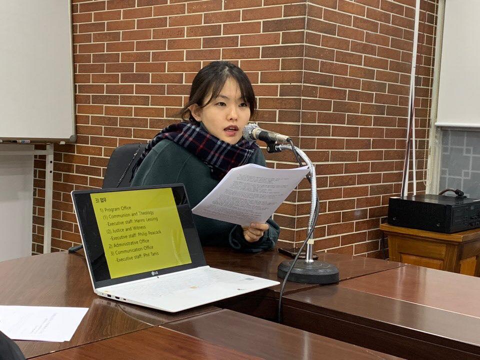 Eri Yoon sitting at a table and talking into a microphone