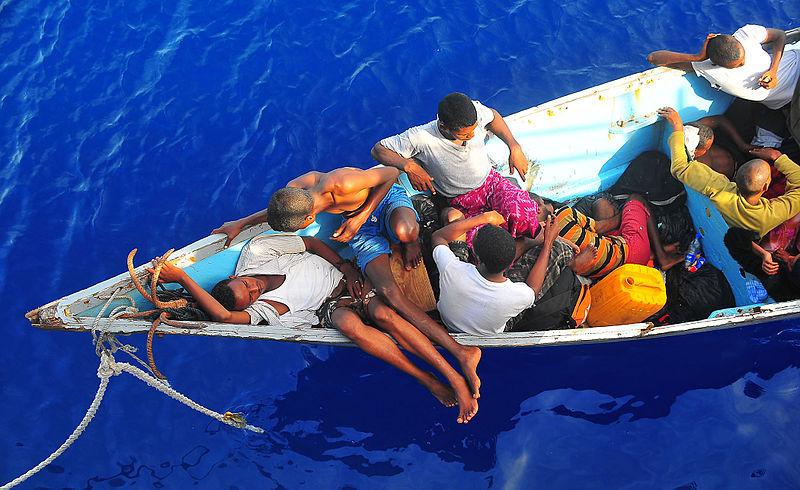 Somali migrants in a disabled skiff wait for assistance.