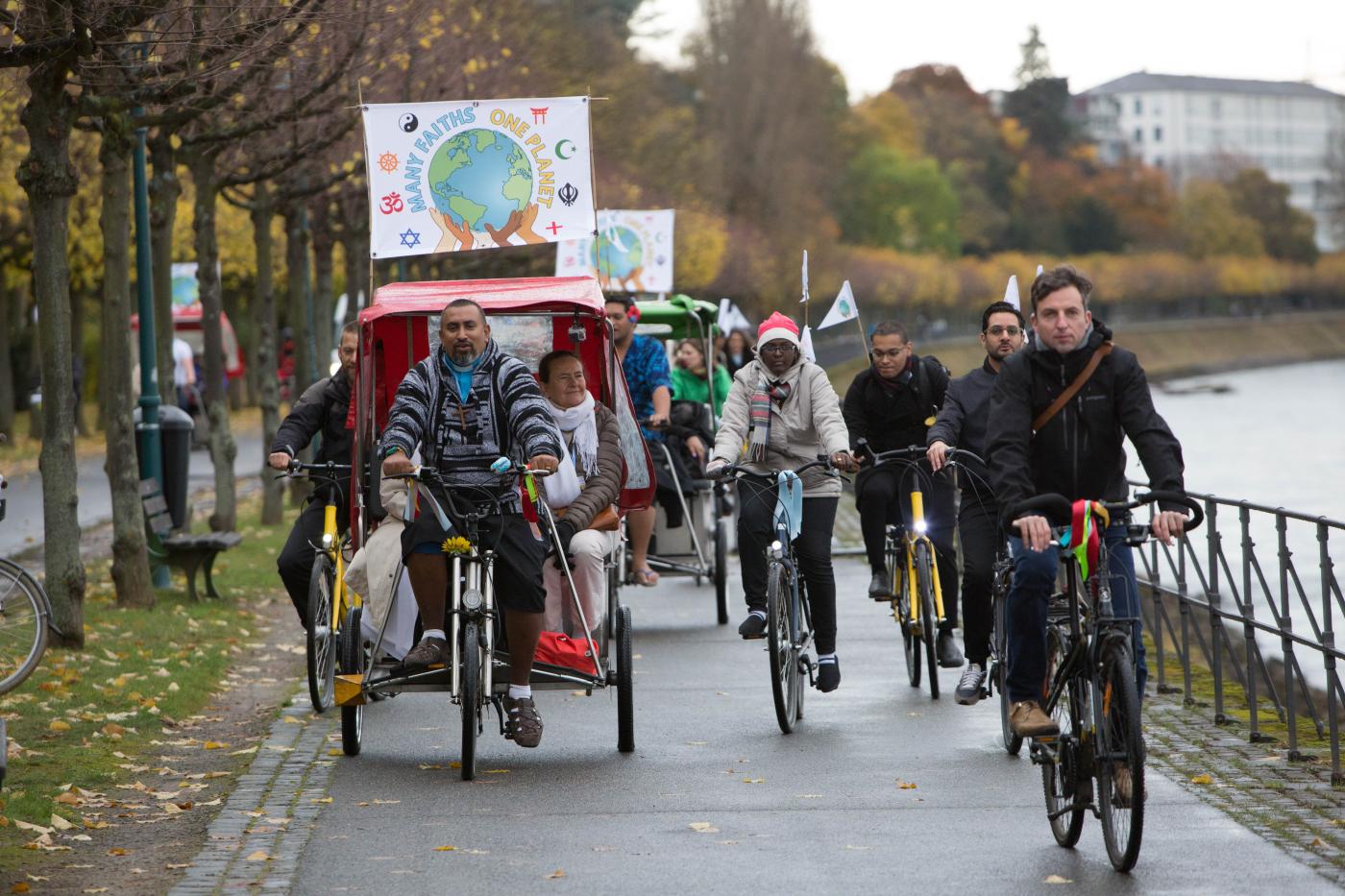 In the picture, Rev. James Bhagwan (L), from Fiji, joins a bike ride along the river Rhine with dozens of cyclists to deliver a multi-faith statement to the United Nations climate conference. ©Sean Hawkey/WCC