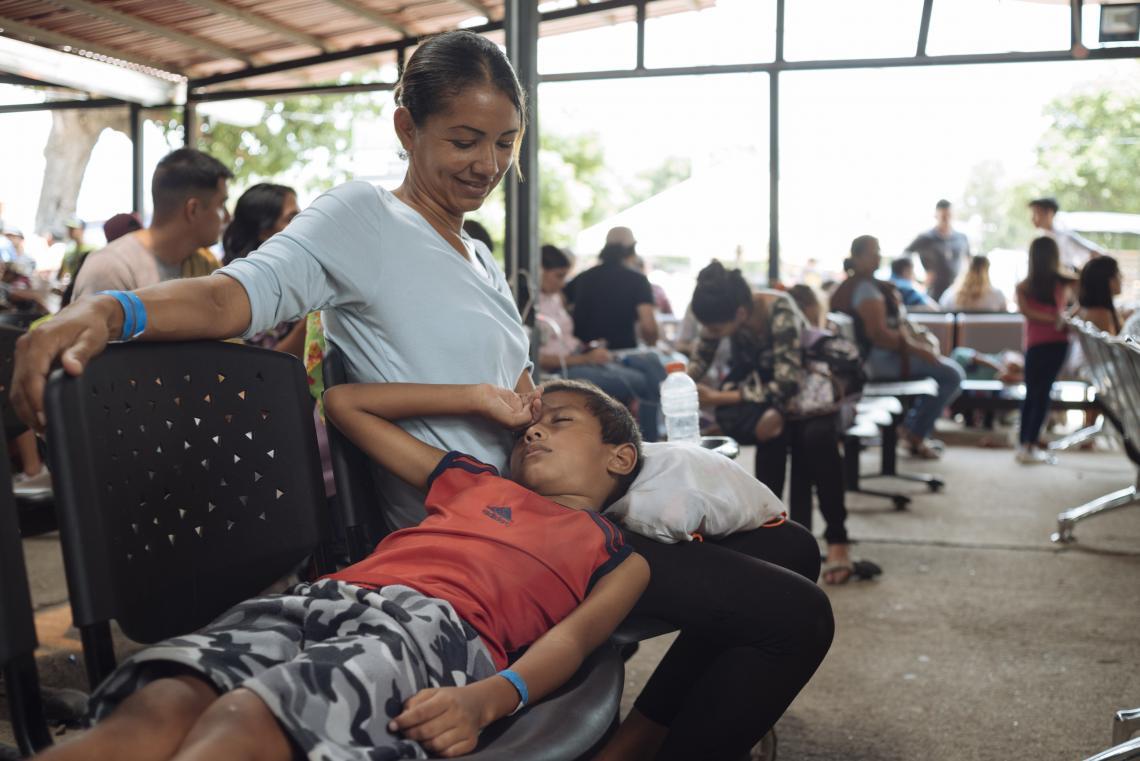A boy rests on his mother’s lap at a migration centre in Cucuta, Colombia, at the Colombian-Venezuelan border.