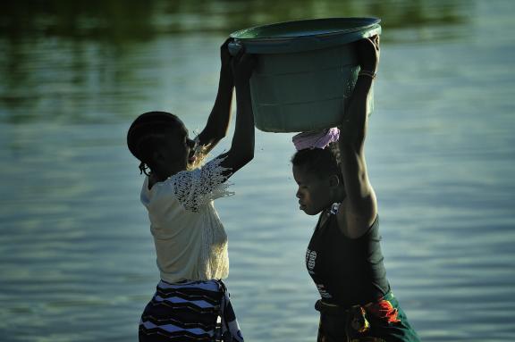 Women help each other at Lake Malawi. 