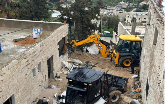 Bulldozer pictured demolishing a building. 