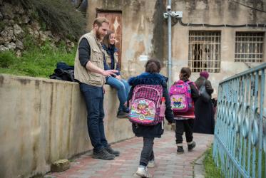 Participants in the Ecumenical Accompaniment Programme in Palestine and Israel greet the children as they undertake a 'school run' in the H2 area of Hebron, by which they offer an international presence as Palestinian children go to school, 2 March 2020, Hebron, Photo: Albin Hillert/WCC 