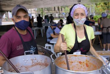 Two volunteers prepare meals for homeless people in Porto Alegre, Brazil. 