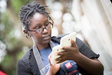 young woman looks at the screen of her phone