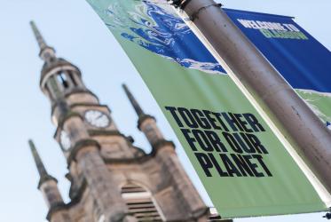 A banner in Glasgow reads "together for our planet"