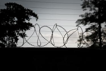 Wall with barbed wire fence