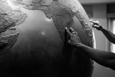 Hands touching a globe