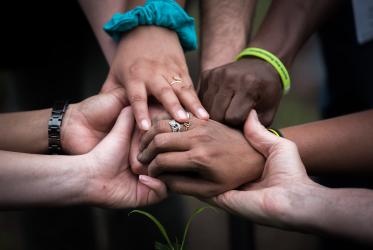 An image of diverse women's hands coming together.
