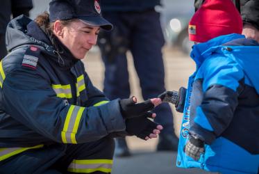 A woman firefighter greets a young refugee child from Ukraine as he arrives at the Vama Siret border crossing, Romania. The Vama Siret border crossing connects northeast Romania with Ukraine. Located north of Siret and further in the south the city of Suceava, the crossing connects Romania with the Ukrainian village of Terebleche and further north the city of Chernivtsi. Following the invasion of Ukraine by Russian military starting on 24 February 2022, close to half a million refugees have fled across the 