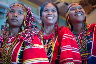Three smiling girls, The graduation ceremony for students of the Lumad Bakwit School - a school set up for the evacuated indigenous Lumad people of Mindanao in the Philippines, Photo: Sean Hawkey/Life on Earth Pictures