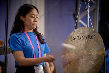 Jooeun Kim of the Presbyterian Church of Korea strikes a gong