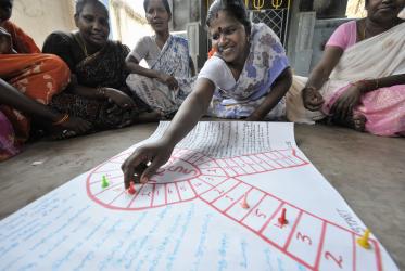 A neighborhood women's group in Chennai, India, learns about HIV and AIDS as they play a game designed by educators from the Madras Christian Council of Social Service.