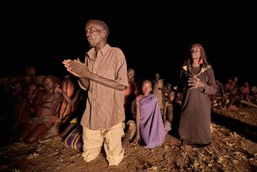 People pray during a nighttime vigil for peace in Nakubuse, a small village near Kuron in South Sudan's Eastern Equatoria State.