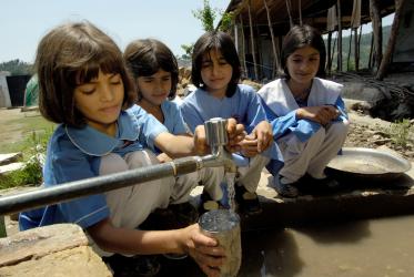 Girls get a drink of water at a public school in Battal, Pakistan.