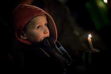 Boy with a candle at the church