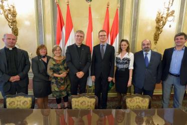 Olav Fykse Tveit, and members of the delegation and the Ecumenical Council of Churches in Hungary with Bence Retvari, parliamentary state secretary of the Ministry of Human Resources. © WCC/Paul Jeffrey
