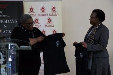 Rev. Phumzile Mabizela (left) presenting a “Thursdays in Black” t-shirt to Prof. Charity Irungu (right), deputy vice chancellor for academic affairs at St Paul’s University in Limuru