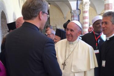 Pope Francis greets the WCC general secretary in Assisi.