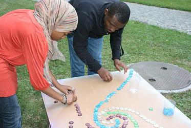 Sarah Abdullah, a Muslim from the US, and Emmanuel Babatunde Gbogboade, a Christian from Nigeria, working on an art project at the interfaith seminar Click here for high resolution