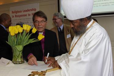 WCC president Abune Paulos, patriarch of the Ethiopian Orthodox Tewahedo Church, signs the "personal commitment to action" issued at the Summit of High Level Religious Leaders on HIV. Photo: © Leo Huizinga/Cordaid