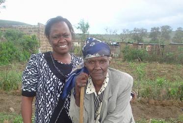 Pauline Wanjiru Njiru with one of Kenya's Grandmothers against Poverty and AIDS. Now in her 80s, Naomi has been bent over since she broke her spine while cutting firewood in order to cook for her orphaned grandchildren.