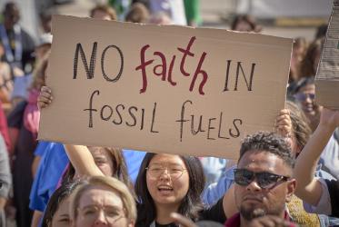 2 September 2022, Karlsruhe, Germany: A young woman holding up a sign that says "no faith in fossil fuels" 